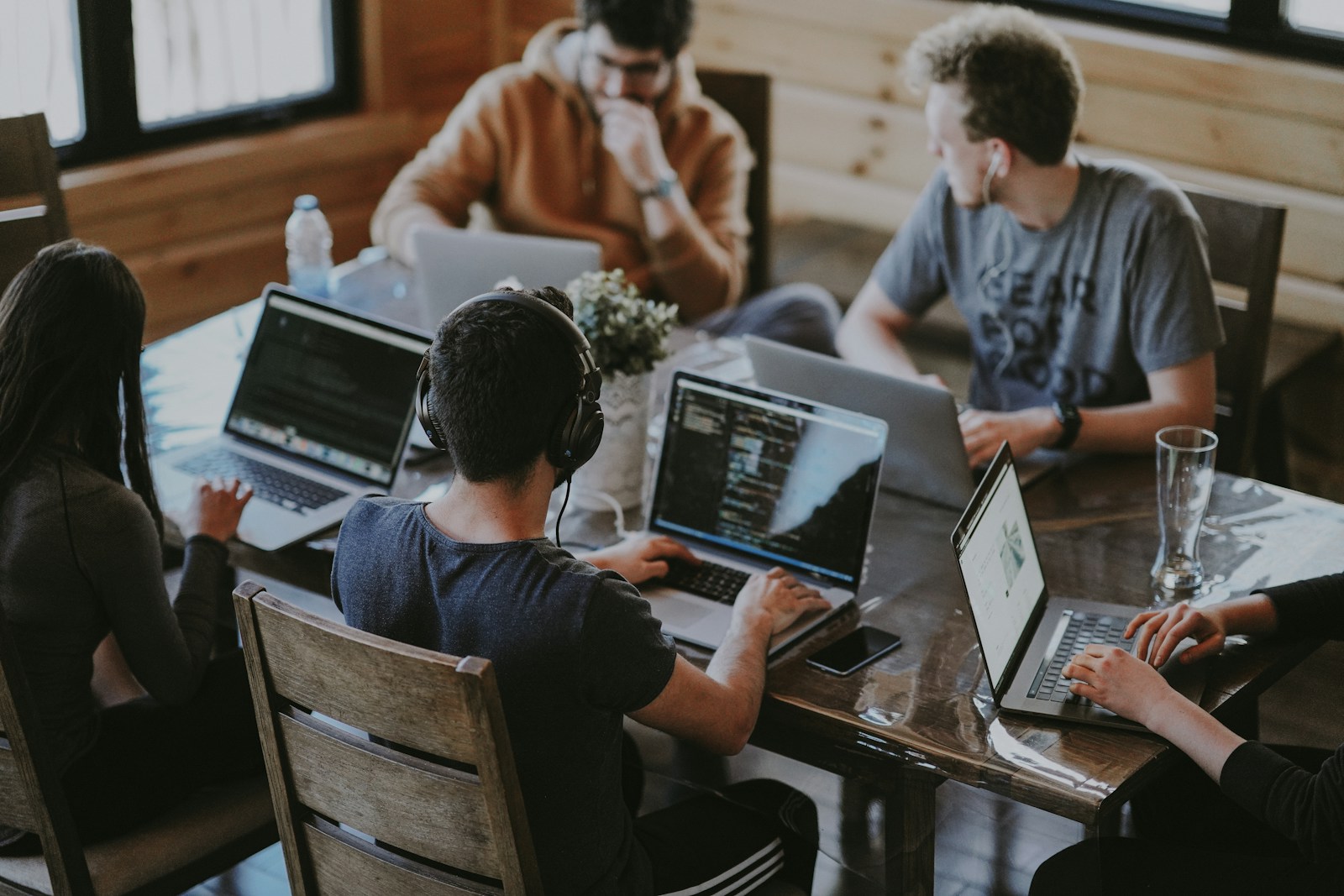 Professionals working together around laptops